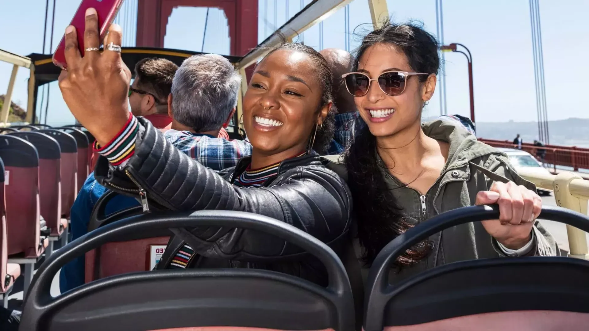 Friends taking selfies on the Golden Gate Bridge